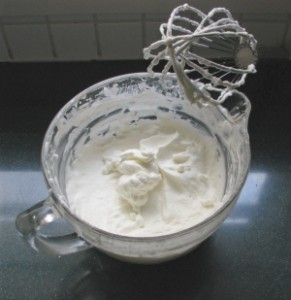 a whisk and whipped cream